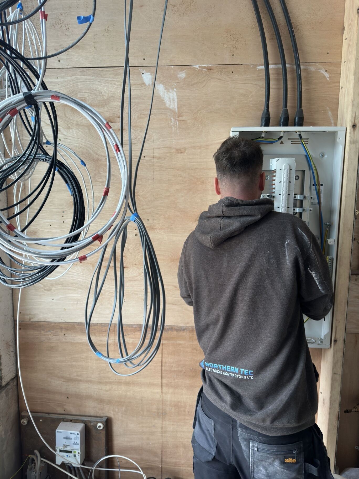 Northern Tec electrician working on a commercial wiring installation