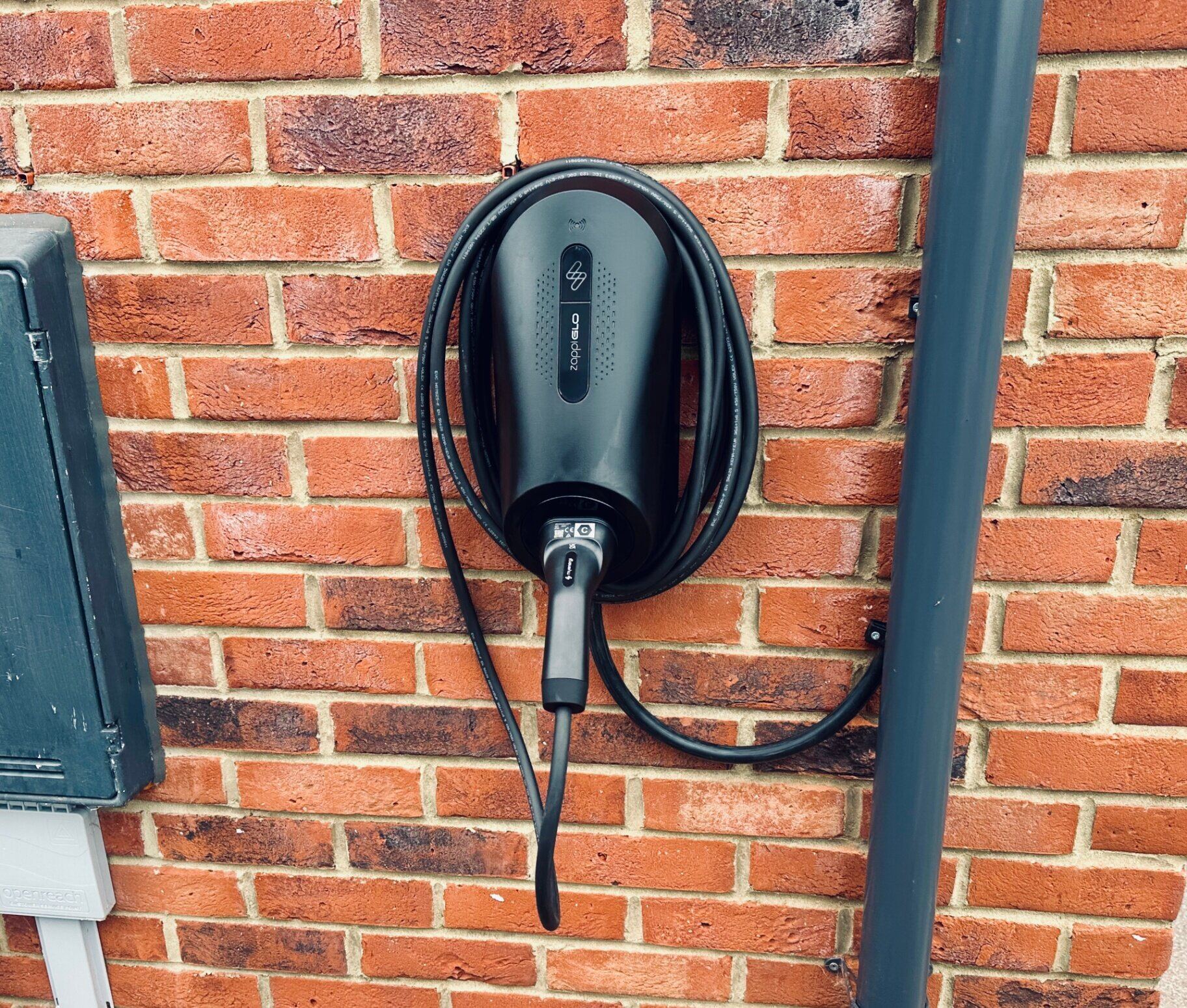 Myenergi Zappi GLO smart EV charger installed on a domestic brick wall by Northern Tec
